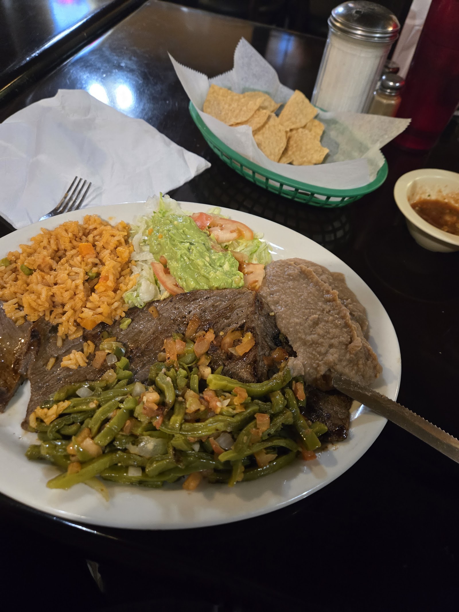 Grilled fajitas plate with rice, beans, guacamole and nopalitos