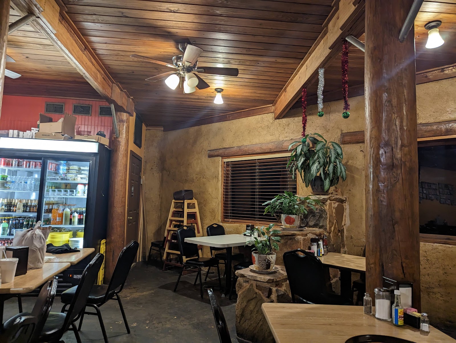 Cozy wood-beam dining room interior at El Rodeo De Jalisco